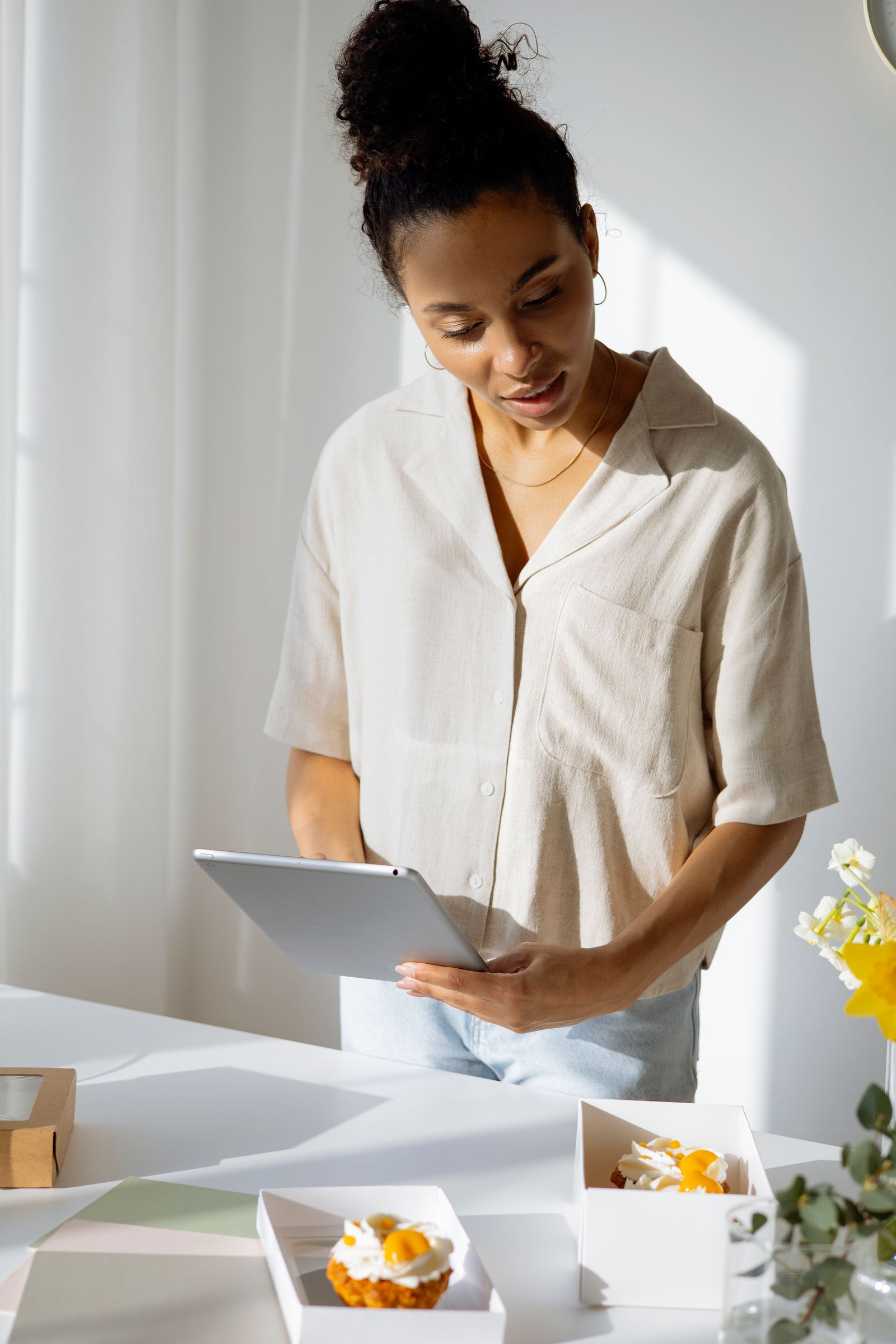 A small business owner managing orders on a tablet